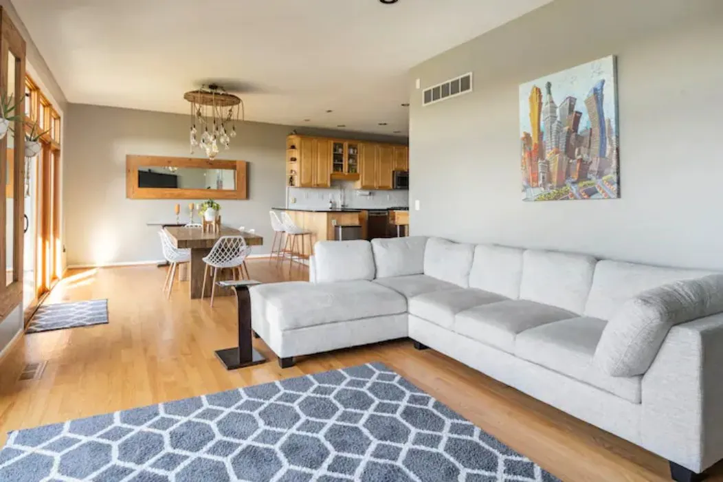 Open living room with a large sectional sofa and dining area beyond